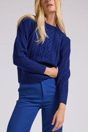 Image of model wearing Generation Love Brooks cable sweater in navy