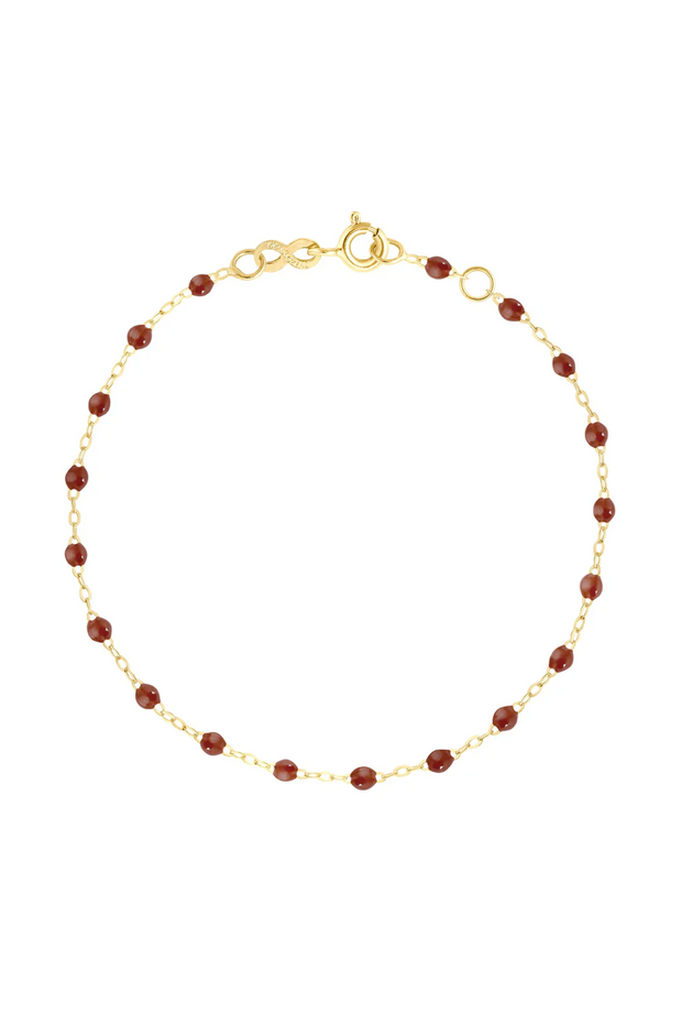 Gold bracelet with moka beads on a white background