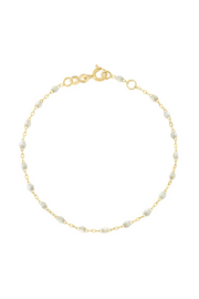 Gold bracelet with opal beads on a white background