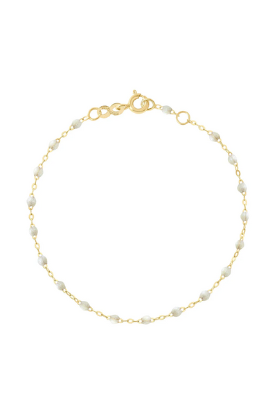 Gold bracelet with opal beads on a white background