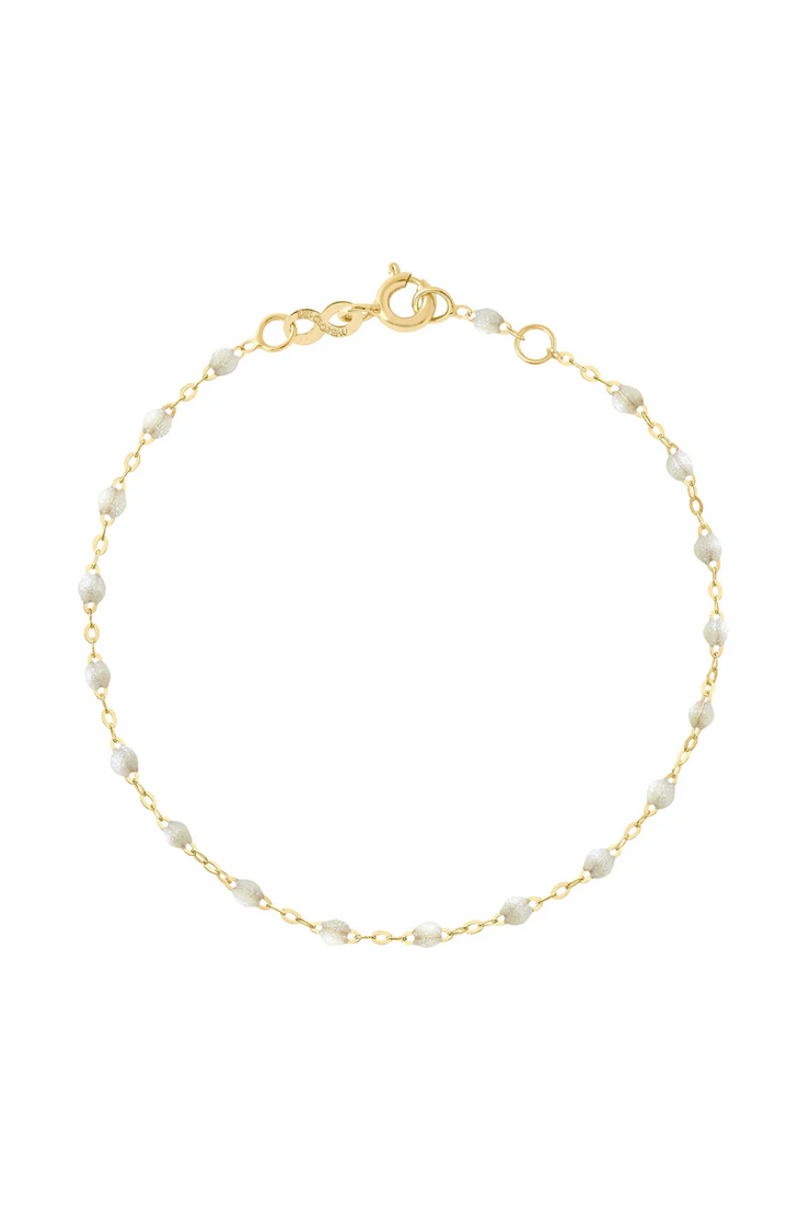 Gold bracelet with opal beads on a white background