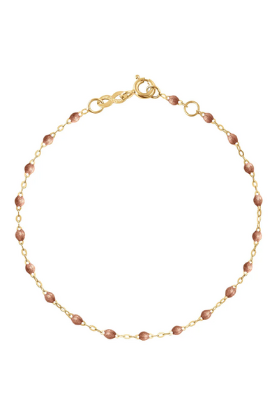 Gold bracelet with copper beads on a white background