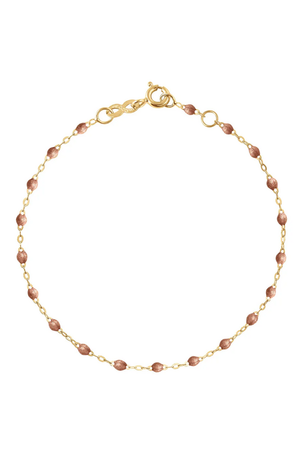 Gold bracelet with copper beads on a white background
