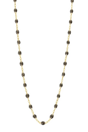 Necklace with quartz beads on a gold chain against a white background