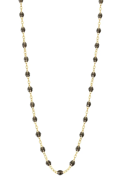 Necklace with quartz beads on a gold chain against a white background