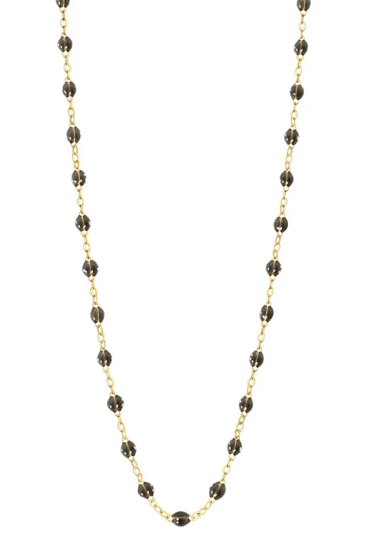 Necklace with quartz beads on a gold chain against a white background