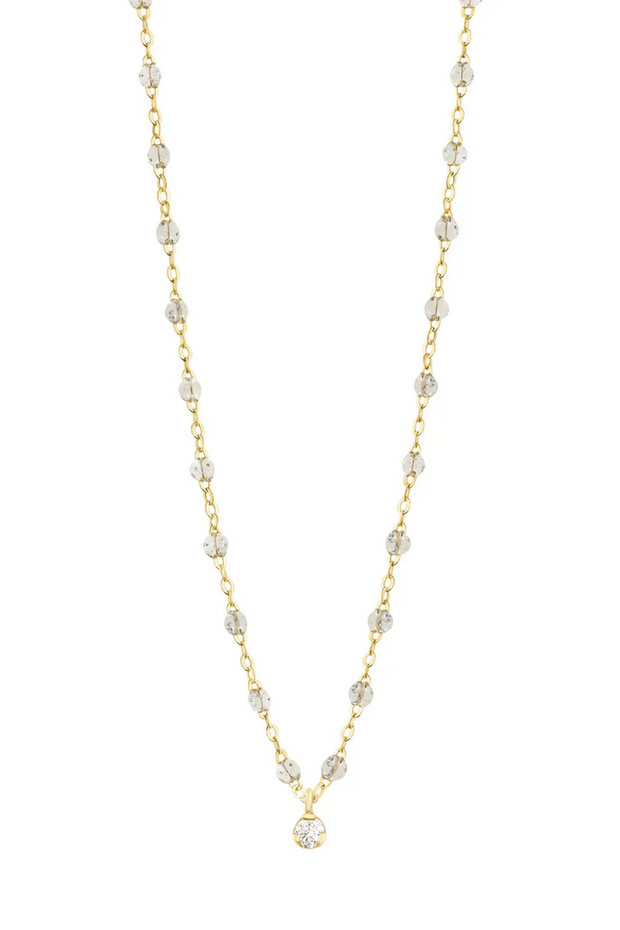 Gold and sparkle beaded necklace on a white background