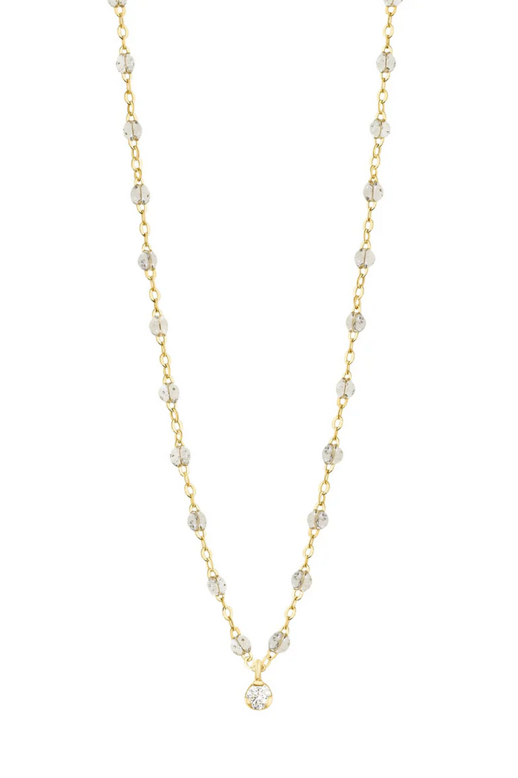 Gold and sparkle beaded necklace on a white background