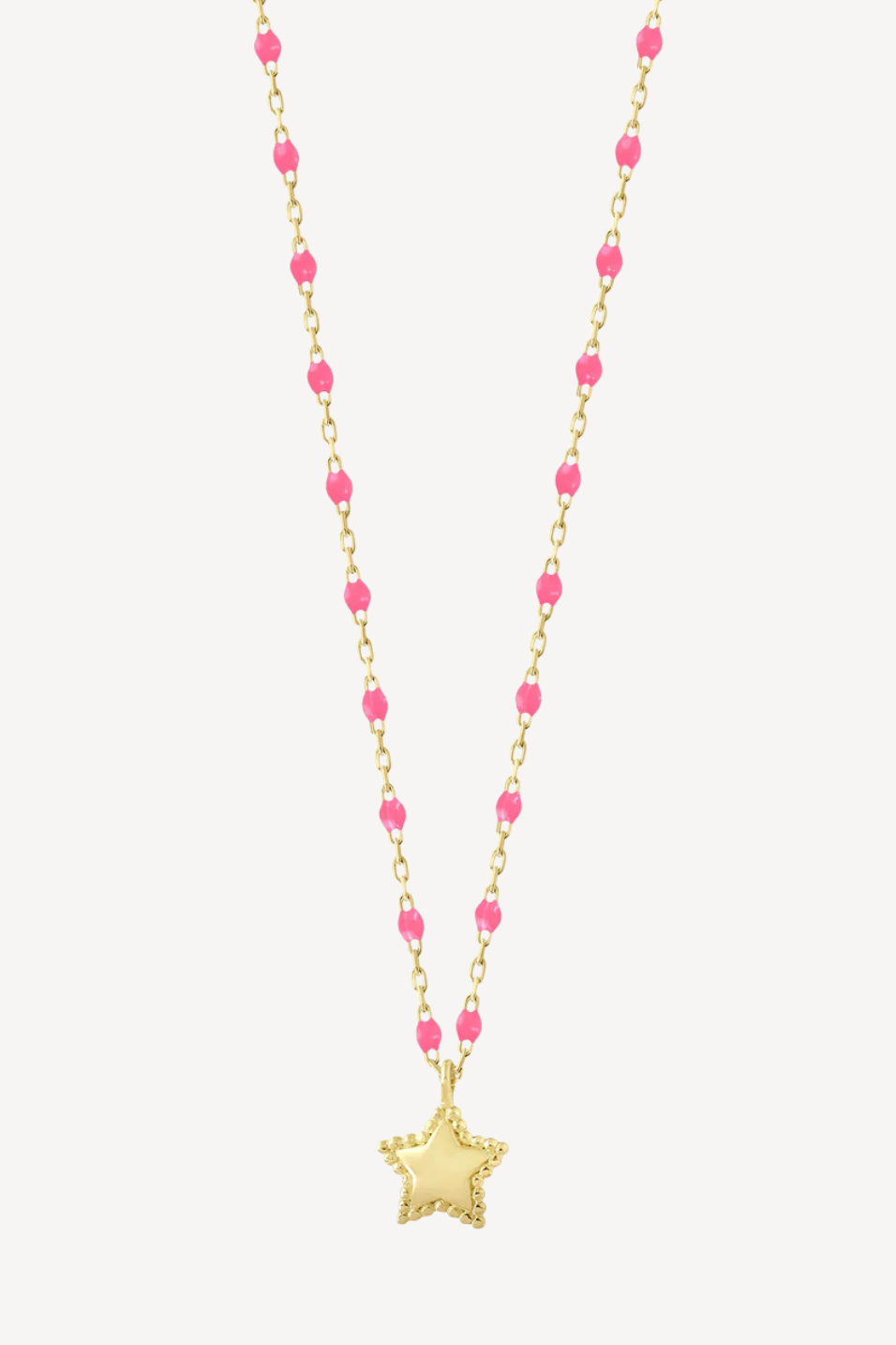 Necklace with pink beads and a gold star pendant on a white background