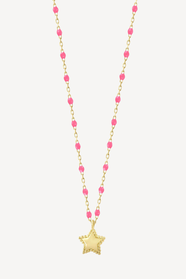 Necklace with pink beads and a gold star pendant on a white background