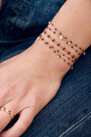 Beaded bracelets on a person's wrist with denim background
