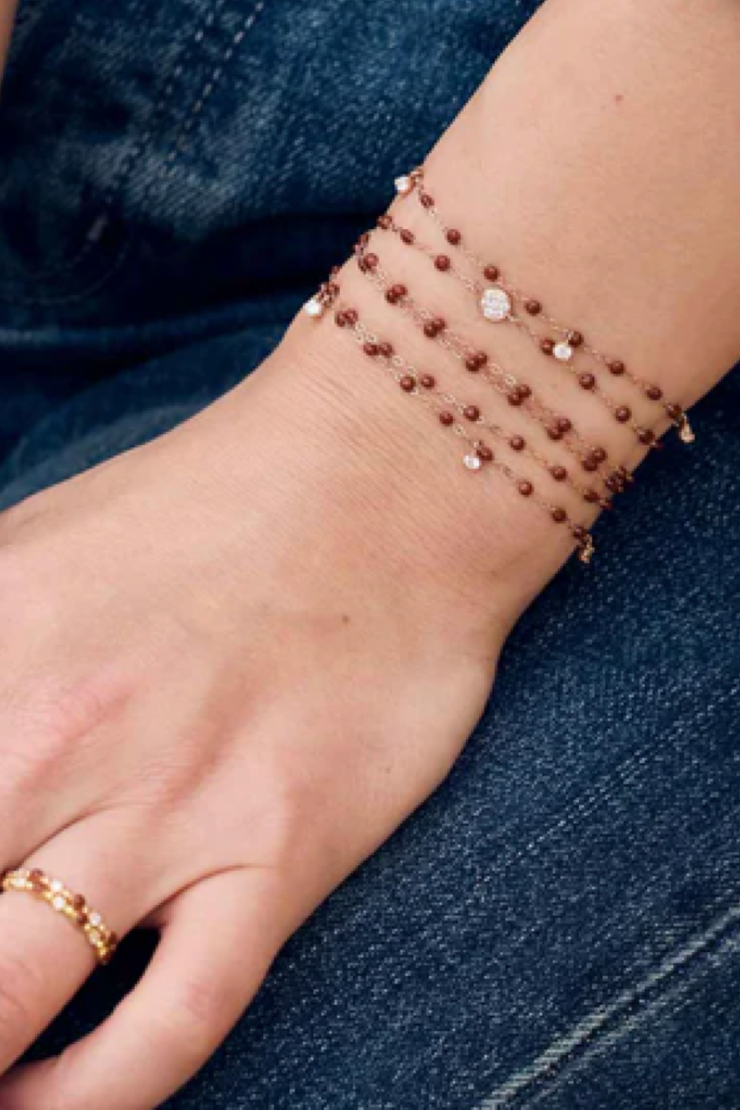 Beaded bracelets on a person's wrist with denim background