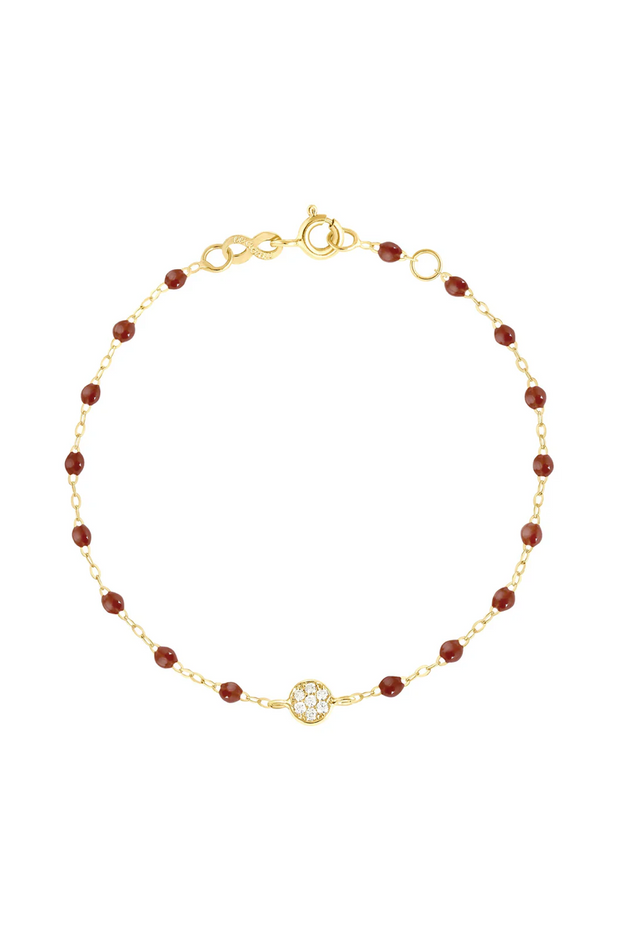 Gold bracelet with moka beads and diamonds on a white background