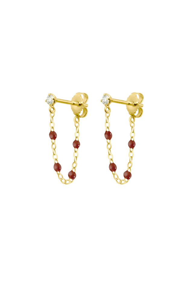 Gold chain earrings with moka beads on a white background