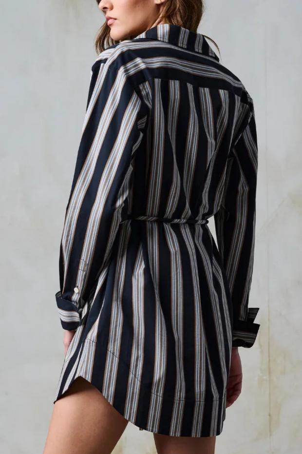 Black and white striped dress worn by a person against a neutral background