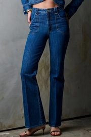 Person wearing blue jeans against a plain background