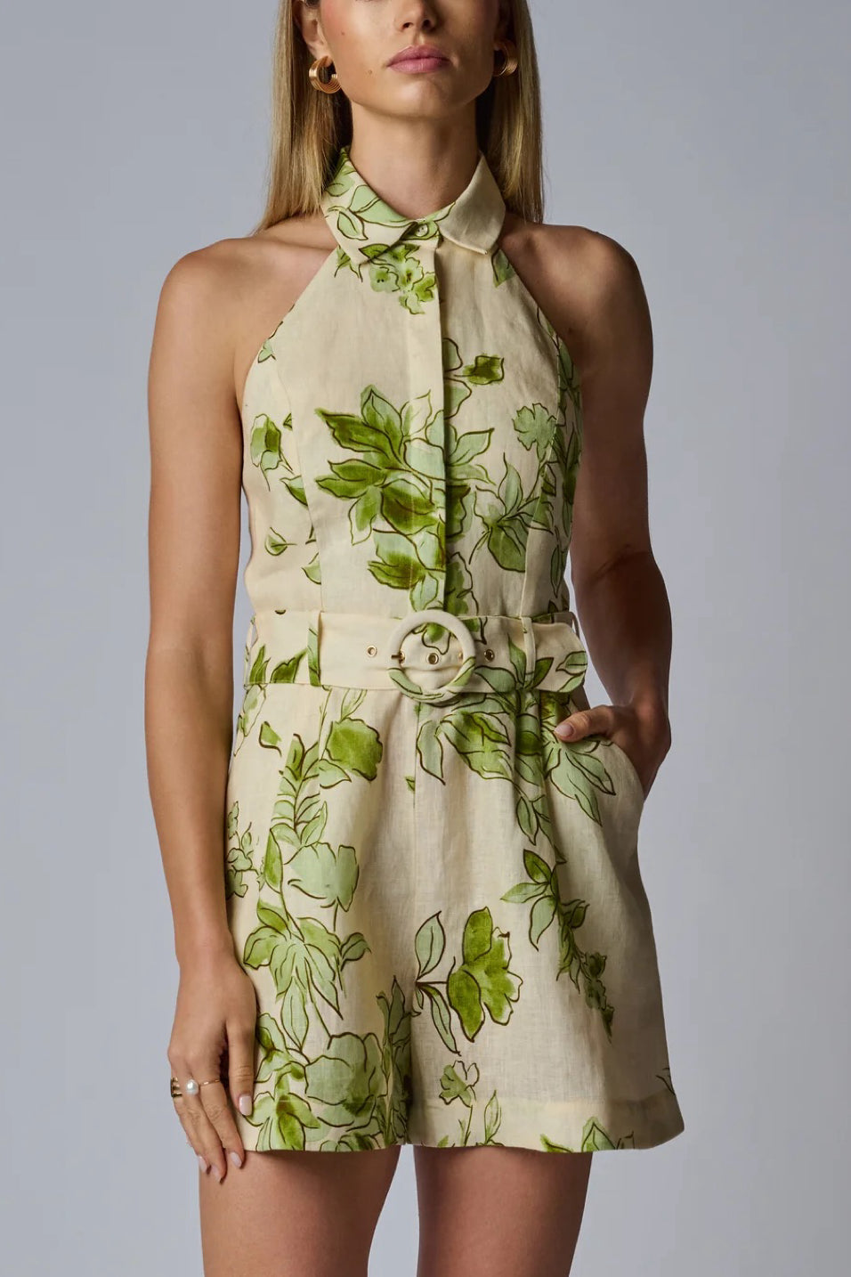 Image of model wearing the Hevron Asha Romper front view with one hand in pocket