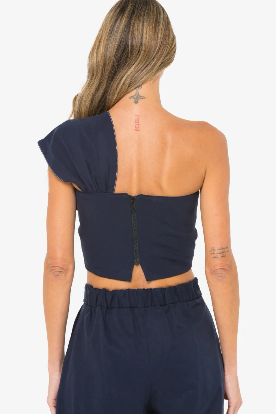 Image of model wearing the Hevron Blaire Top back view