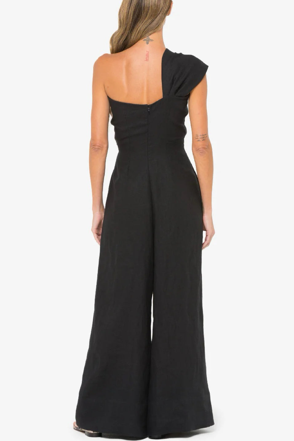 Image of model wearing the Hevron Eden Jumpsuit back view