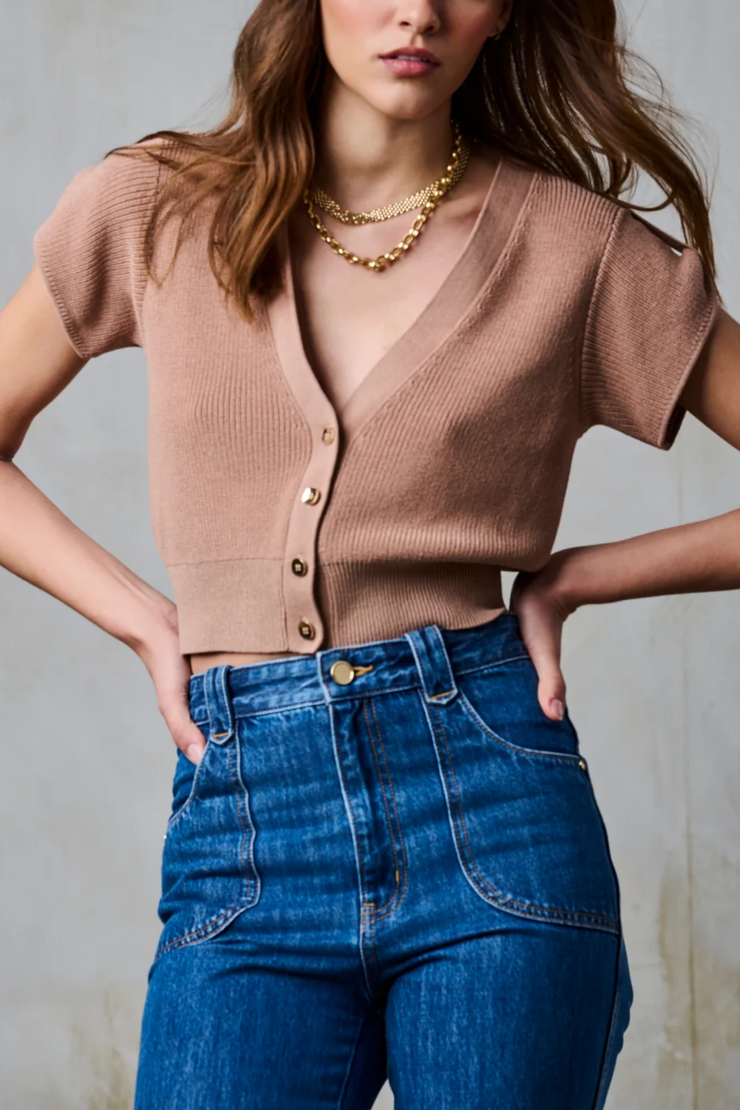 Model wearing a taupe short sleeve knit