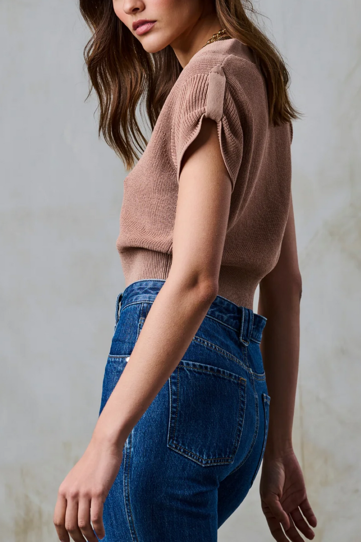 Model wearing a taupe short sleeve knit