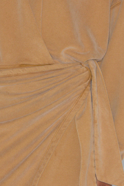 Close-up of a caramel fabric with a draped effect