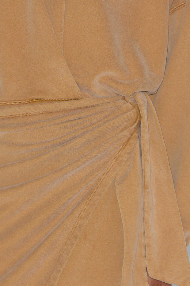 Close-up of a caramel fabric with a draped effect