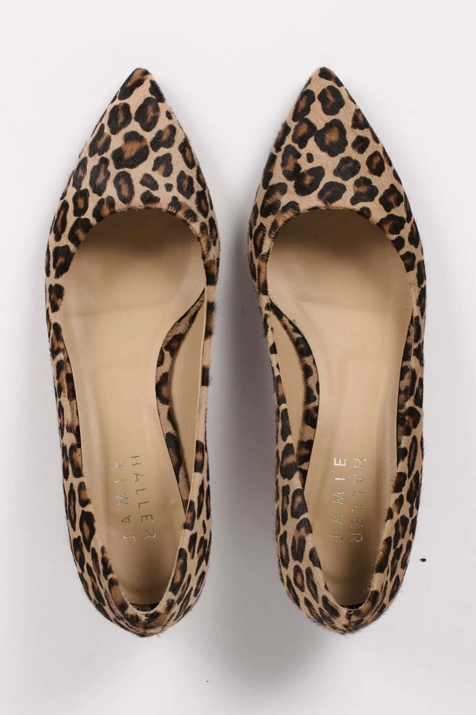 Pair of leopard print high heels on a white background