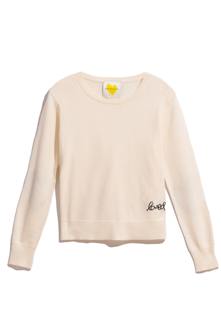 Cashmere sweater with 'love' embroidery on a white background