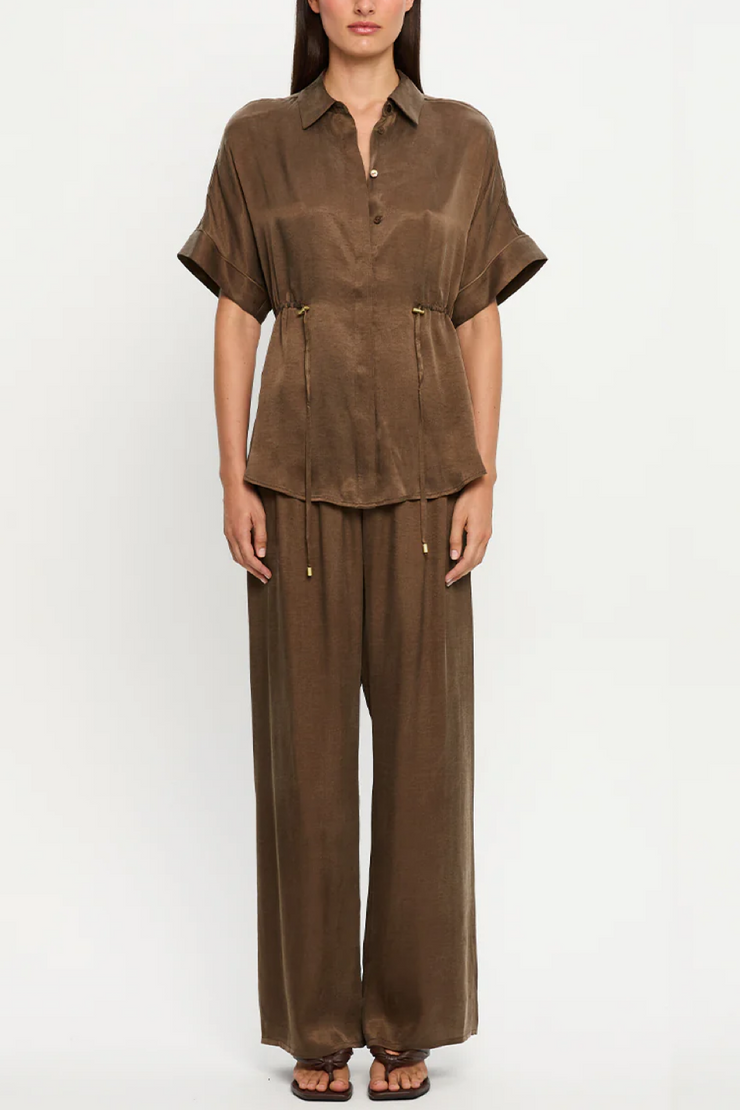 Mocha outfit with a shirt and wide-leg pants on a white background