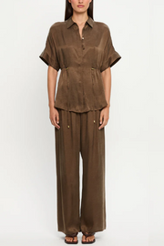 Mocha outfit with a shirt and wide-leg pants on a white background