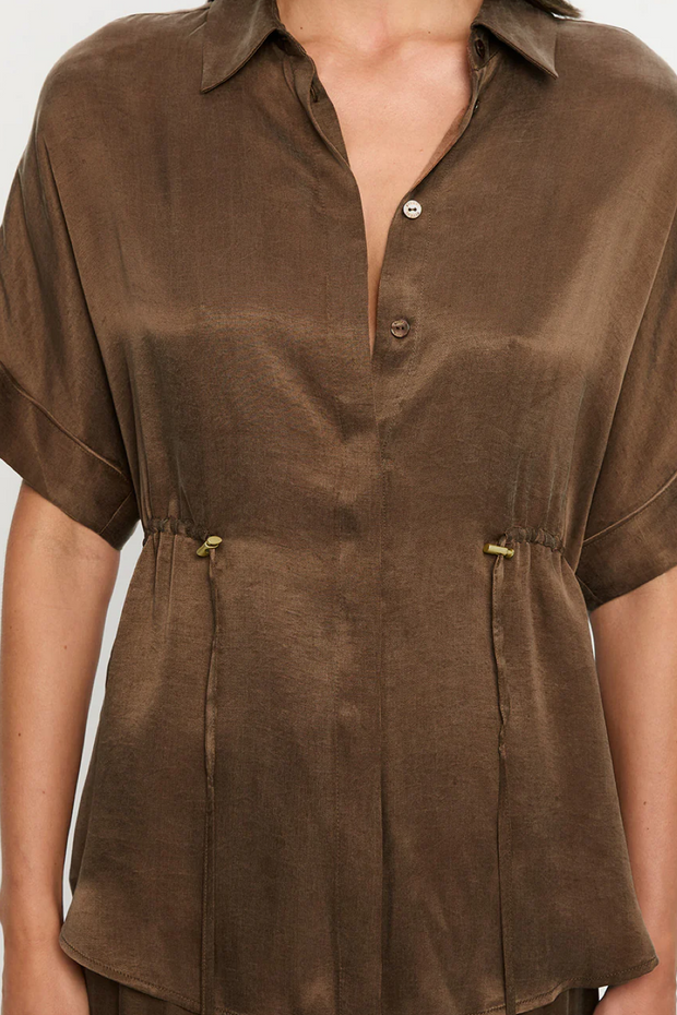 Mocha short-sleeve blouse worn by a person on a white background