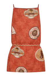 Red apron with vintage-style hotel logo patterns on a white background