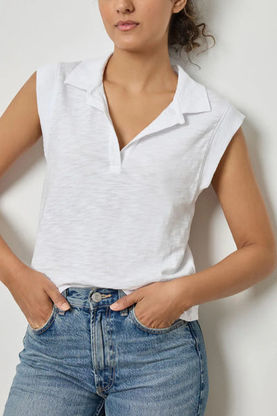 Image of model wearing the lilla p cap sleeve polo front view with hands in pockets