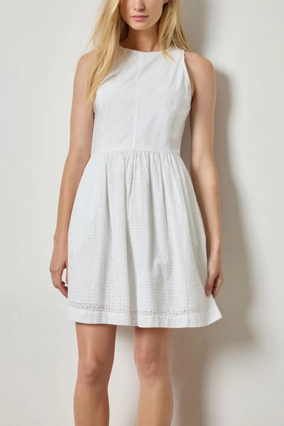 Image of model wearing the lilla p eyelet high neck mini dress front view with hands down by sides