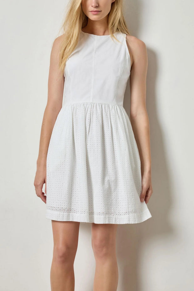 Image of model wearing the lilla p eyelet high neck mini dress front view with hands down by sides