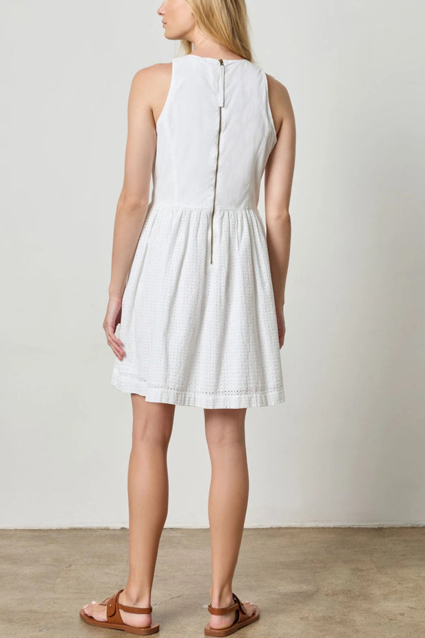 Image of model wearing the eyelet high neck mini dress back view