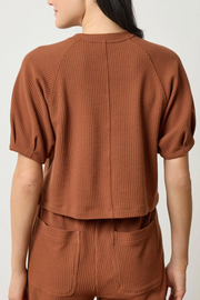Praline waffle textured top and pants worn by a person on a white background