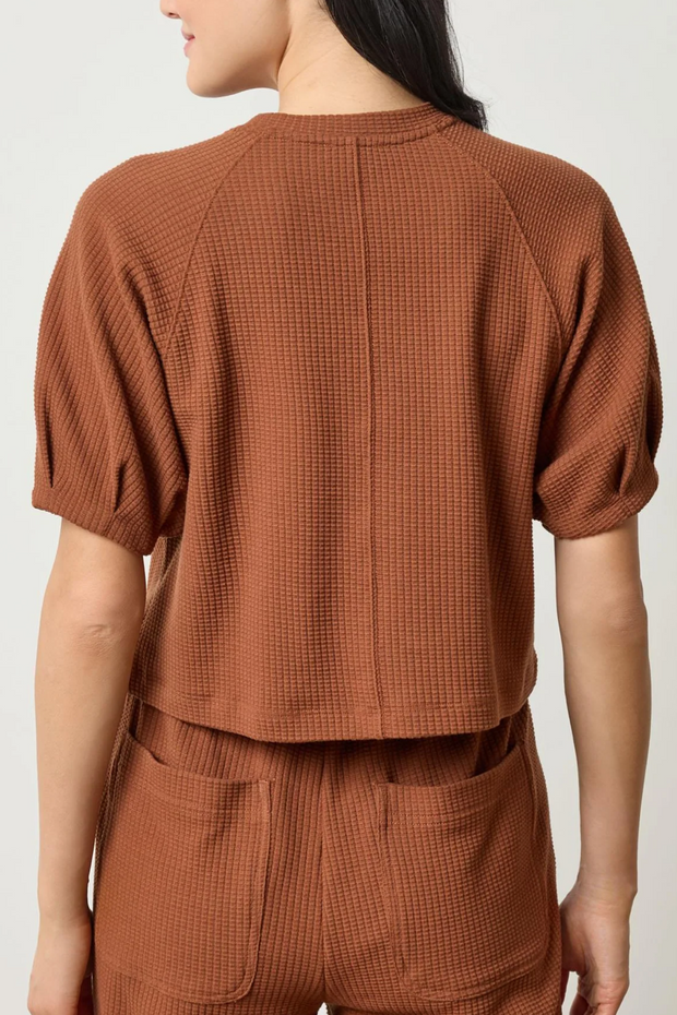 Praline waffle textured top and pants worn by a person on a white background