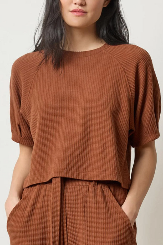 Woman wearing a praline waffle outfit on a white background