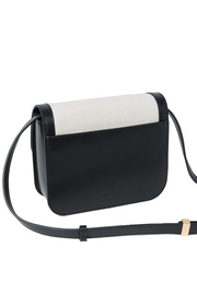 Black and white handbag on a light gray background