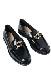 Black loafers with gold accents on a white background