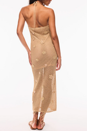 Woman wearing a beige crochet dress on a white background