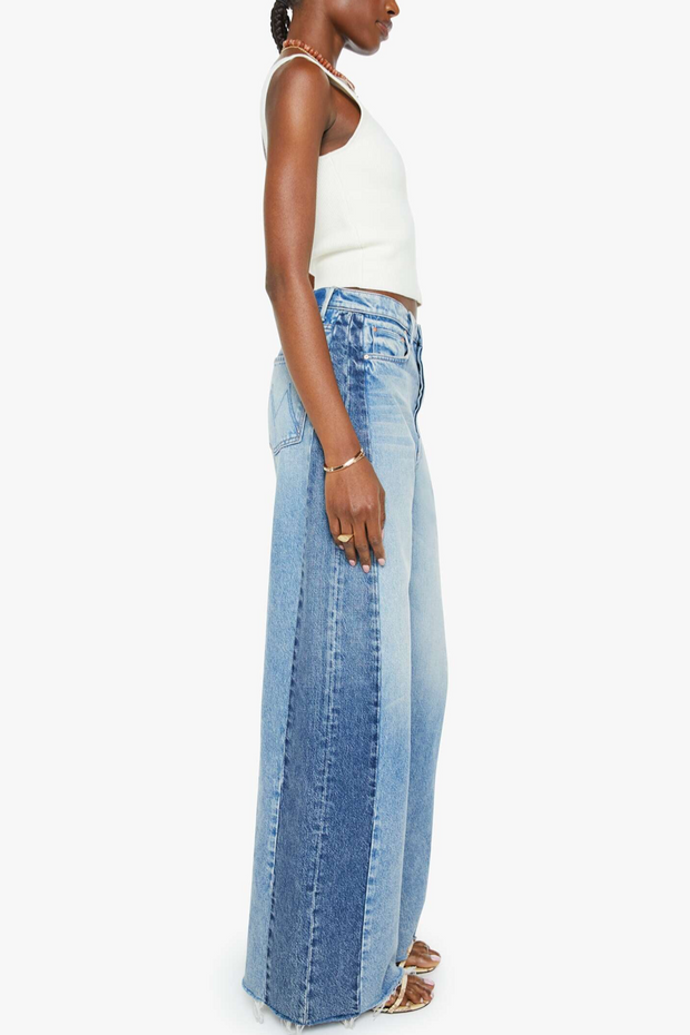 Woman wearing a white top and blue jeans on a white background