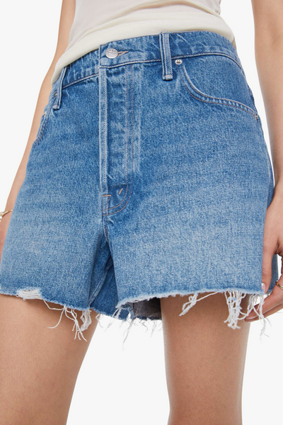 Blue denim shorts with frayed hem on a white background
