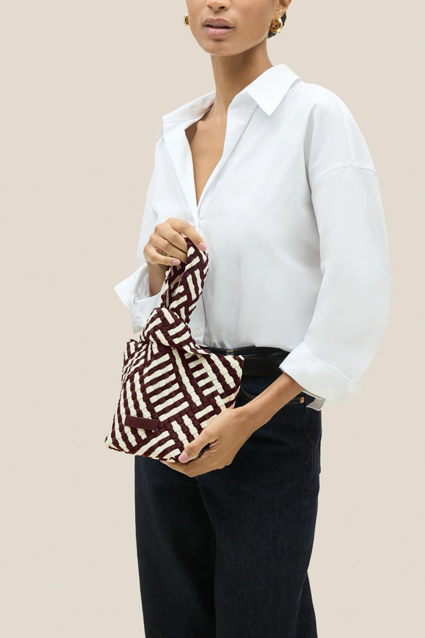 Image of the Naghedi Kyoto Clutch Graphic Stripe on model