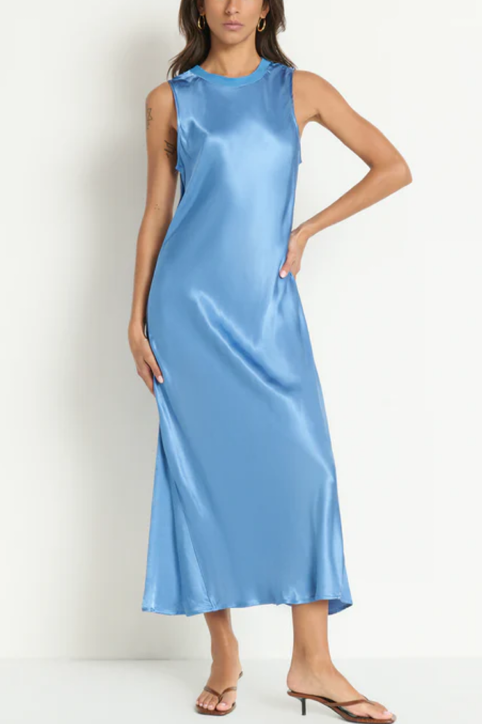 Woman wearing a light blue satin dress against a white background