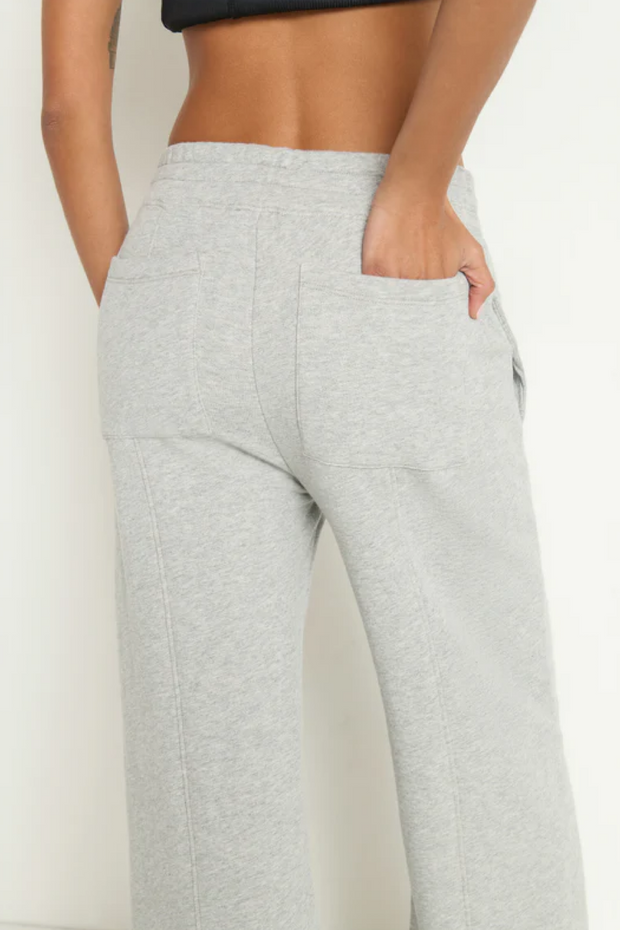 Gray sweatpants worn by a person on a white background