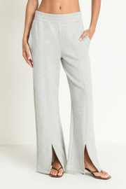 Grey wide-leg sweatpants worn by a person on a white background