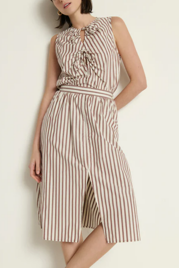 Woman wearing a striped tank and skirt against a plain background